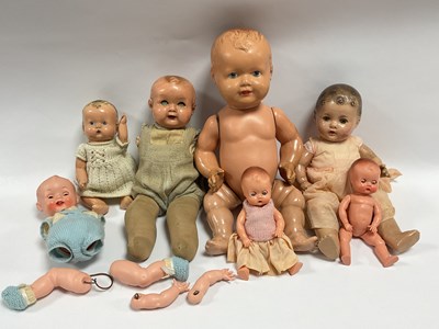 Lot 394 - Seven Composite and Plastic dolls, including a...