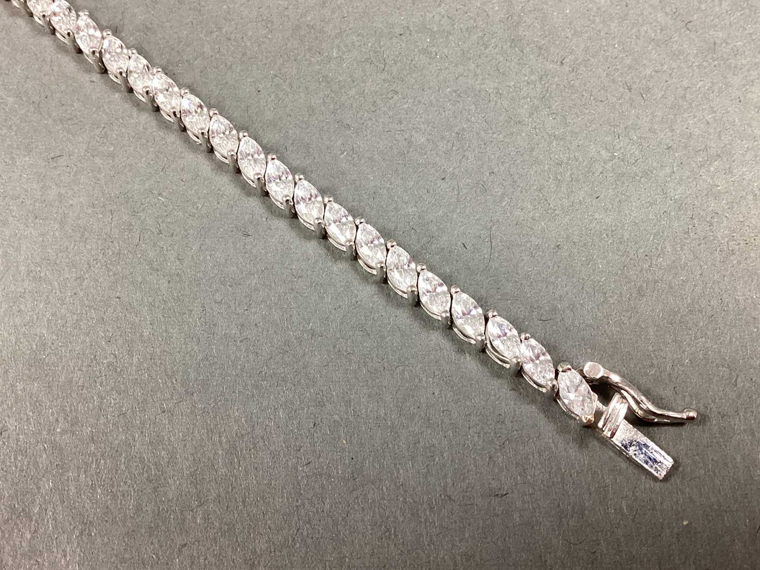 Lot 81 - CARAT London; A Claw Set Marquise Tennis...