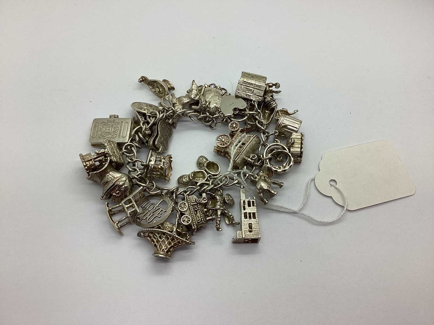 Lot 92 - A Curb Link Bracelet, suspending numerous...