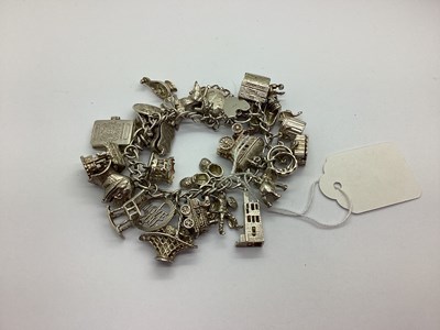 Lot 92 - A Curb Link Bracelet, suspending numerous...