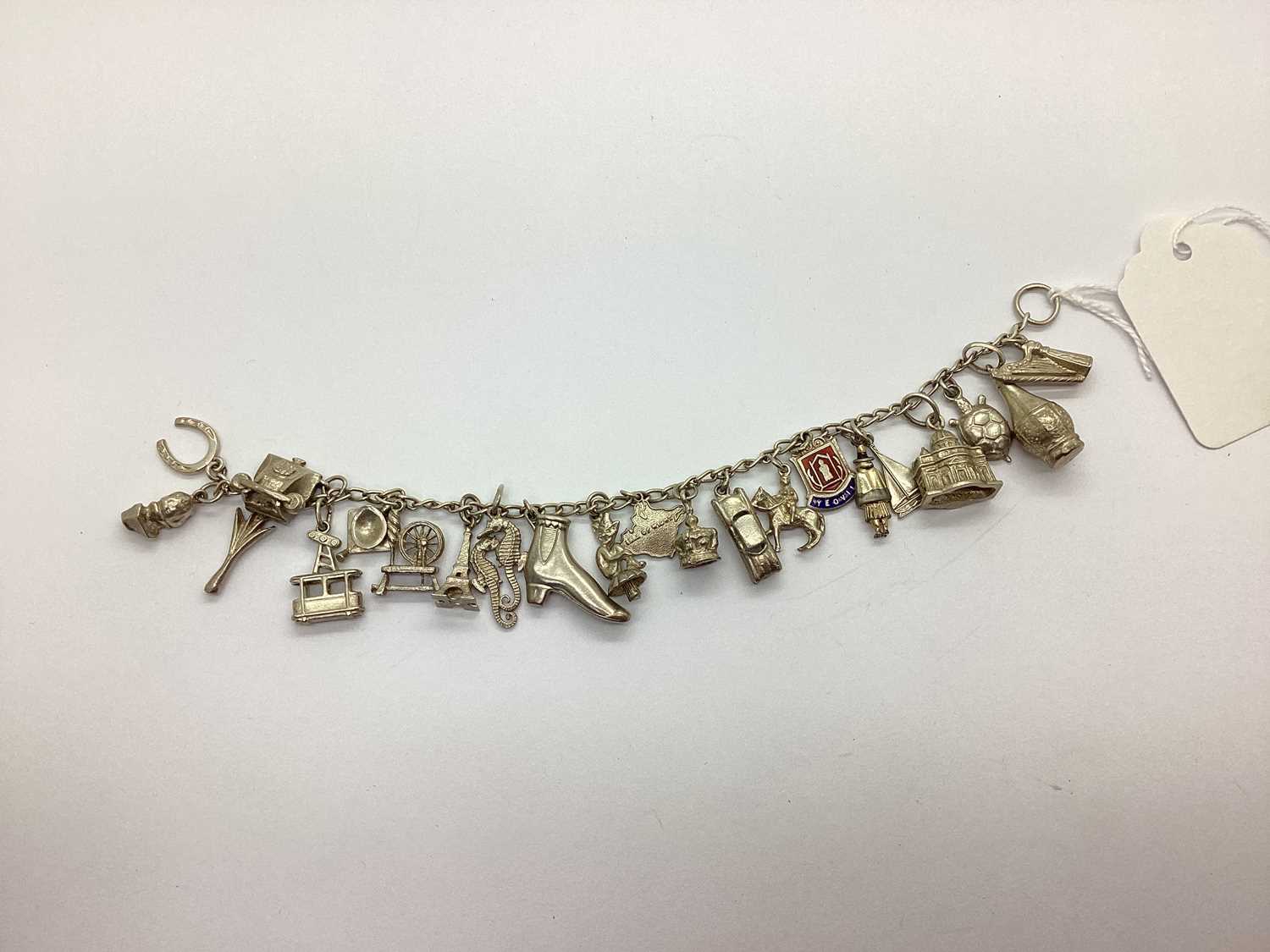 Lot 94 - A Curb Link Bracelet, suspending assorted...