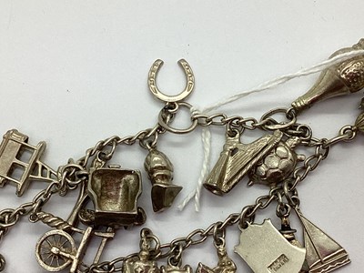 Lot 94 - A Curb Link Bracelet, suspending assorted...