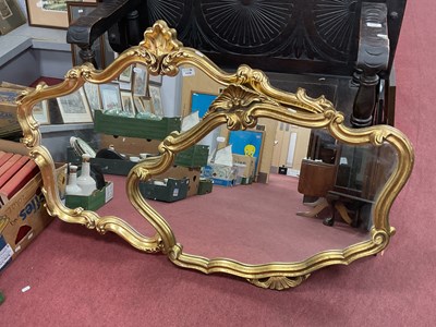 Lot 1438 - A pair of Rococo-style gilt wall mirrors, each...