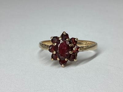Lot 43 - A 9ct Gold Claw Set Cluster Ring, of oval...