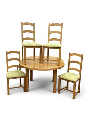 Lot 1550 - A modern light oak circular extending dining...