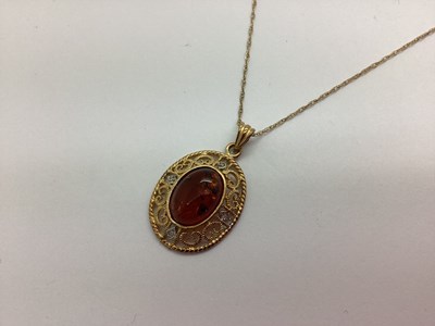 Lot 84 - A 9ct Gold Amber Set Pendant, oval collet set...