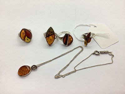 Lot 157 - Four Assorted Amber Coloured Rings, each...