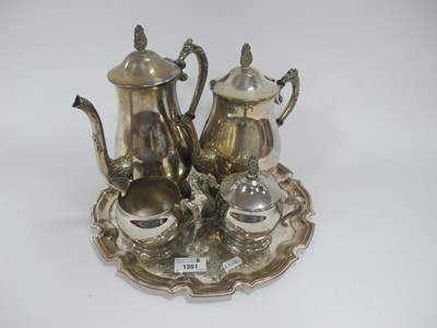 Lot 1251 - A vintage four-piece silver-plated tea and...