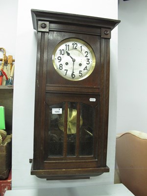 Lot 1043 - A vintage wooden cased wall clock, featuring...