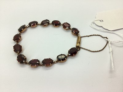 Lot 126 - An Oval Claw Set Garnet Bracelet, to push...