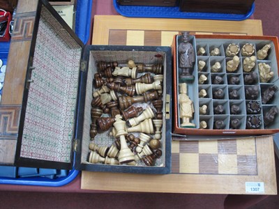 Lot 1307 - Two chess sets with a wooden inlaid chessboard,...