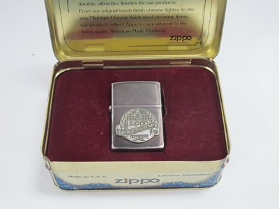 Lot 1212 - Zippo '60th Anniversary' Lighter in a metal...