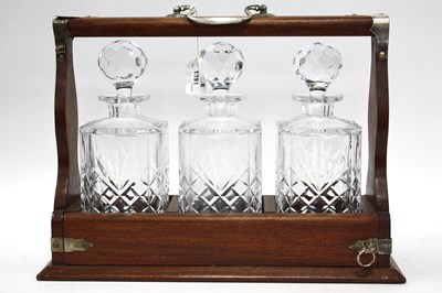 Lot 1391 - An early 20th century oak tantalus, fitted...