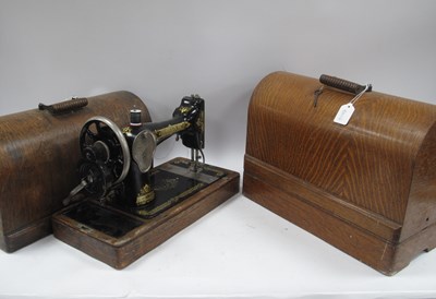 Lot 1470 - Two vintage Singer sewing machines in wooden...