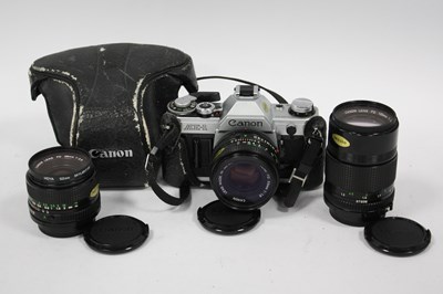 Lot 1047 - Canon AE-1 35mm SLR Film Camera with attached...