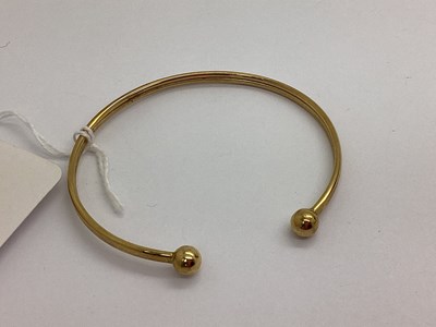 Lot 96 - A Modern 9ct Gold Torque Style Bangle.
