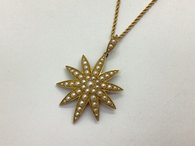 Lot 106 - An Edwardian Pearl Set Starburst Pendant,...