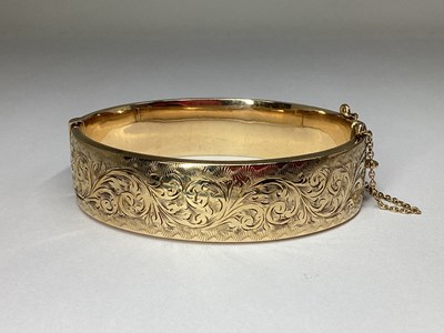Lot 166 - A 1970's 9ct Gold Wide Hinged Bangle, leaf...
