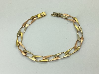 Lot 152 - A 9ct Three Colour Gold Elongated Flat Curb...
