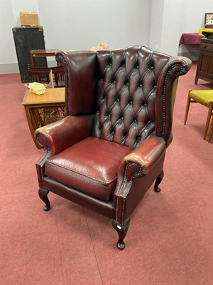 Lot 1486 - Oxblood Leather Button Back Wing Arm Chair,...