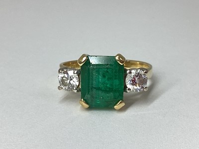 Lot 180 - A Modern Emerald and Diamond Three Stone Ring,...