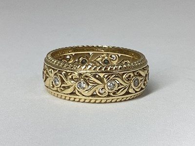 Lot 188 - A Decorative Pierced Band, with collet rubover...