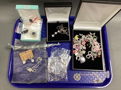 Lot 156 - A Trace Link Charm Bracelet, with a quantity...