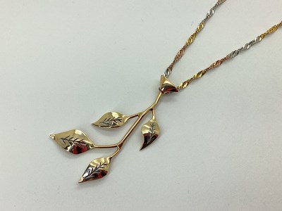 Lot 77 - A Stylised Leaf Spray Pendant, of two tone...