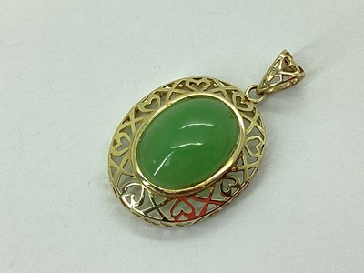 Lot 88 - A Modern Jade Pendant, oval collet set within...